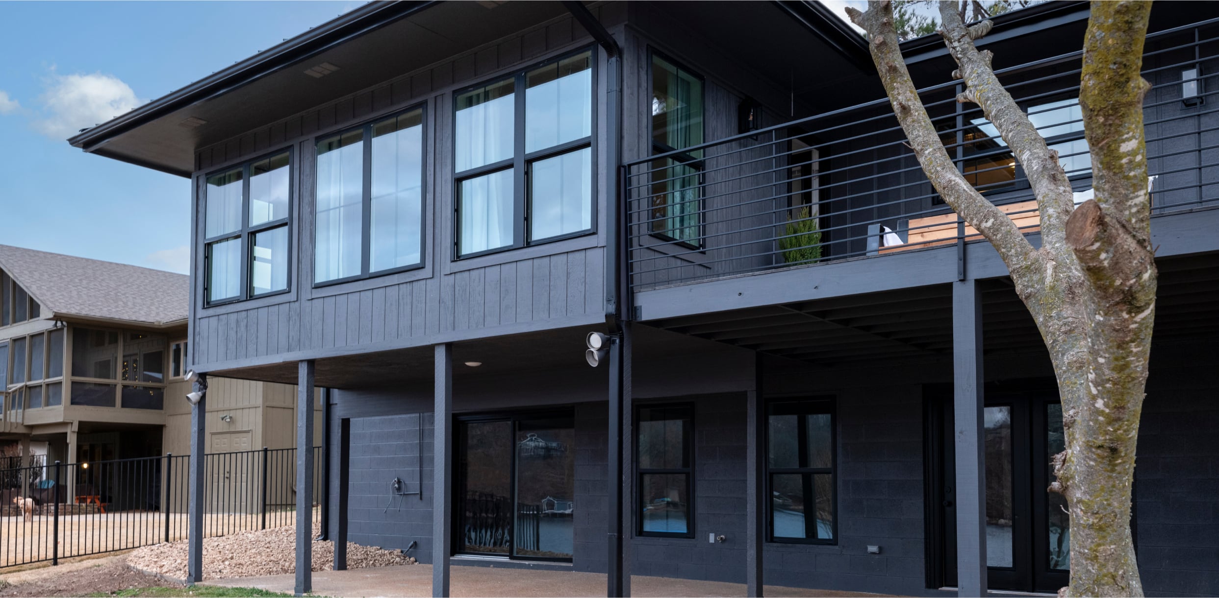 Home with 1500 Series Black Exterior Single Hung and Picture Windows